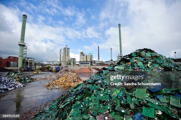 Electronic components including circuit boards sit in a pile before being melted down at the Aurubis recycling smelter on April 14, 2014 in Luenen,...