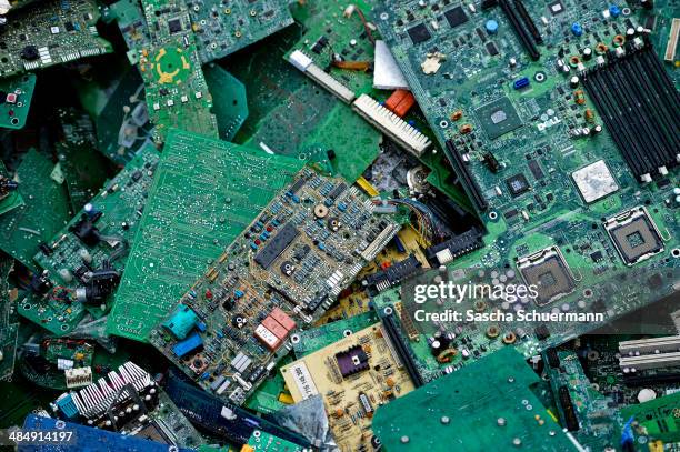 Electronic components including circuit boards sit in a pile before being melted down at the Aurubis recycling smelter on April 14, 2014 in Luenen,...