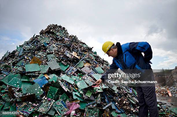 Electronic components including circuit boards sit in a pile before being melted down at the Aurubis recycling smelter on April 14, 2014 in Luenen,...