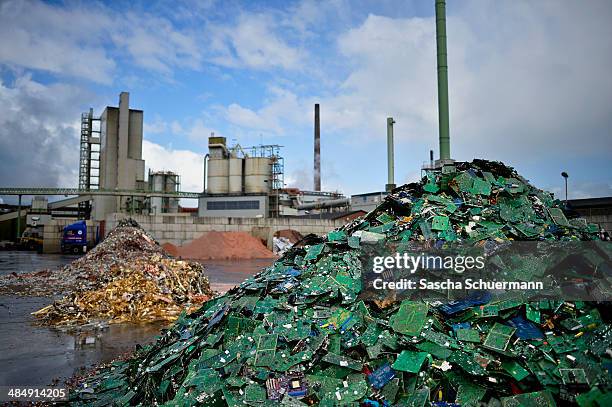 Electronic components including circuit boards sit in a pile before being melted down at the Aurubis recycling smelter on April 14, 2014 in Luenen,...