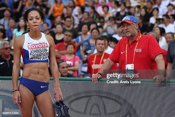 Katarina Johnson-Thompson of Great Britain speaks with coach Mike Holmes after competing in the Women's Heptathlon Long Jump during day two of the...