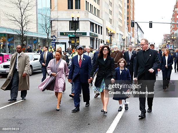 Massachusetts Governor Deval Patrick walks with his wife, Diane, and members of the victims families during a wreath-laying ceremony commemorating...