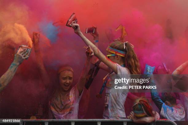 People participate in the annual Color Run after party in Centennial Park in Sydney on August 23, 2015. The Color Run is a 5km fun run started in the...