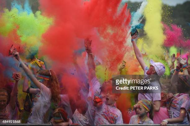 People participate in the annual Color Run after party in Centennial Park in Sydney on August 23, 2015. The Color Run is a 5km fun run started in the...