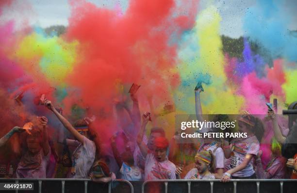 People participate in the annual Color Run after party in Centennial Park in Sydney on August 23, 2015. The Color Run is a 5km fun run started in the...