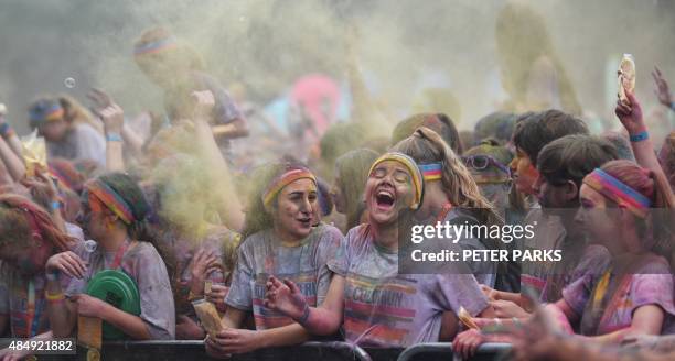 People participate in the annual Color Run after party in Centennial Park in Sydney on August 23, 2015. The Color Run is a 5km fun run started in the...