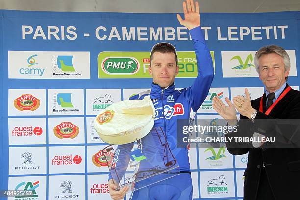 Third-placed FDJ.fr team's Laurent Pichon of France waves on the podium after the 75th edition of the Paris-Camembert cycling race on April 15, 2014...