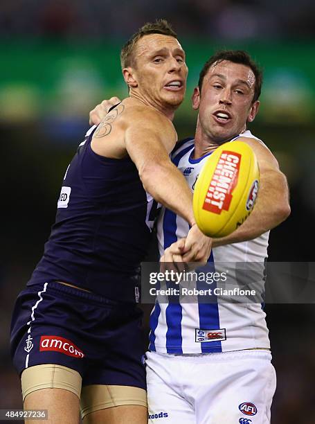 Jonathon Griffin of the Dockers and Todd Goldstein of the Kangaroos compete for the ball during the round 21 AFL match between the North Melbourne...