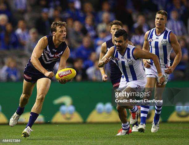Cameron Sutcliffe of the Dockers handballs during the round 21 AFL match between the North Melbourne Kangaroos and the Fremantle Dockers at Etihad...
