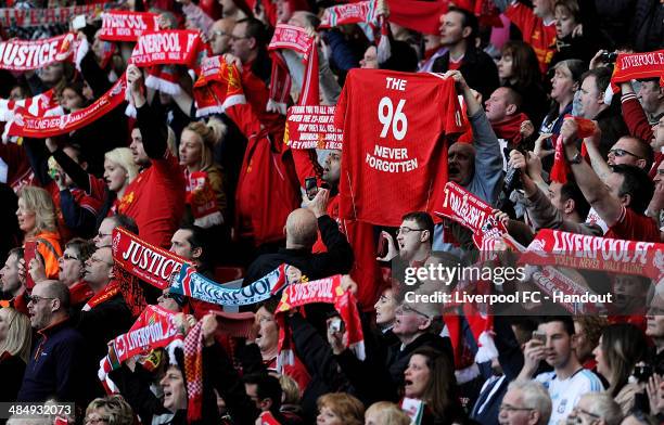 In this handout image provided by Liverpool FC, fans of Liverpool hold scarves and shirts aloft during the 25th Hillsborough Anniversary Memorial...