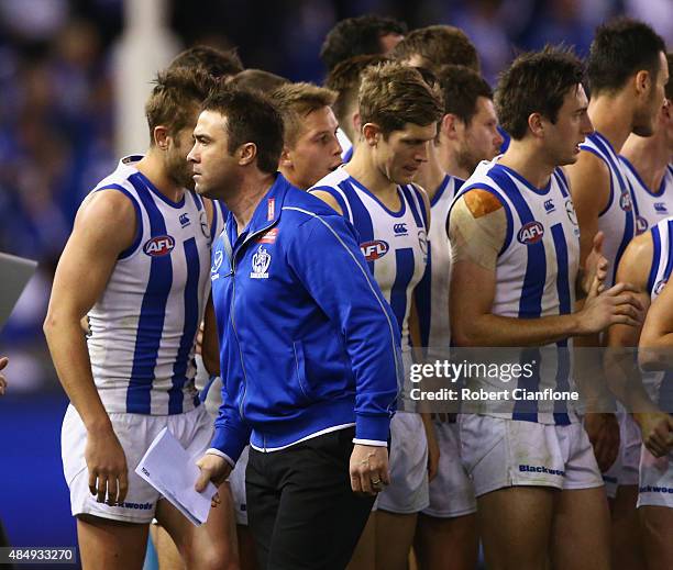 Kangaroos coach Brad Scott is seen after speaking to his players at the break during the round 21 AFL match between the North Melbourne Kangaroos and...