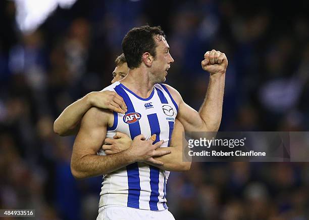 Todd Goldstein of the Kangaroos celebrates with Nick Del Santo after scoring a goal during the round 21 AFL match between the North Melbourne...