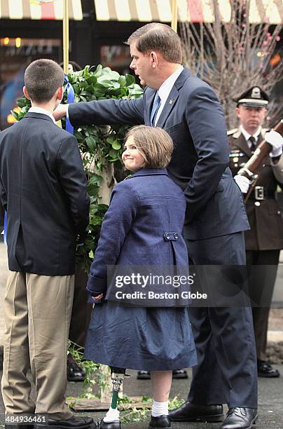 Mayor Martin J. Walsh, right, participated in a wreath laying ceremony in front of the Forum Restaurant, one of the two bombing sites, in Copley...