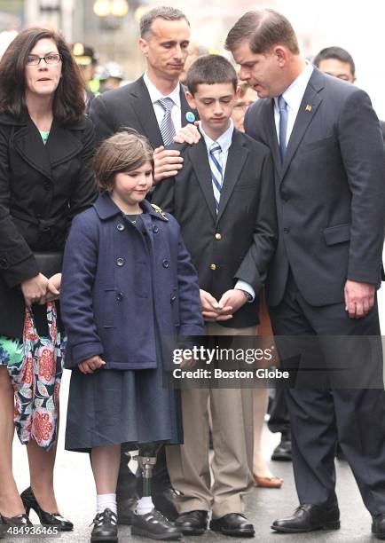 Mayor Martin J. Walsh , right, expressed condolences to the family of bombing victim Martin Richard, including his parents, Denise and Bill, sister,...