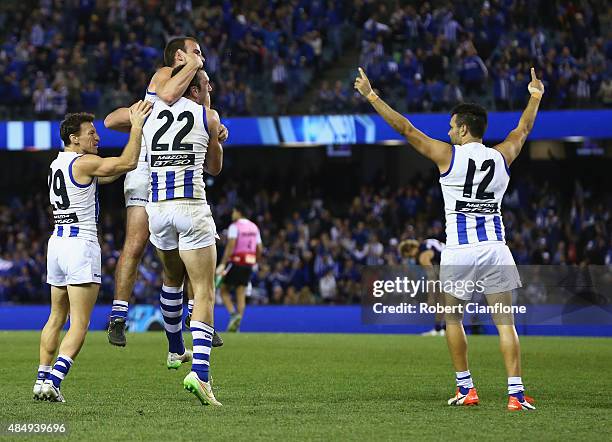 The Kanagroos celebrate after they defeated the Dockers during the round 21 AFL match between the North Melbourne Kangaroos and the Fremantle Dockers...