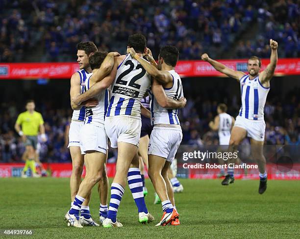 The Kanagroos celebrate after they defeated the Dockers during the round 21 AFL match between the North Melbourne Kangaroos and the Fremantle Dockers...