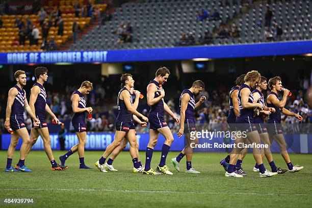 The Dockers walk from the ground after they were defeated by the Kangaroos during the round 21 AFL match between the North Melbourne Kangaroos and...