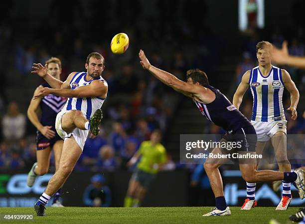 Ben Cunnington of the Kangaroos kicks the ball during the round 21 AFL match between the North Melbourne Kangaroos and the Fremantle Dockers at...