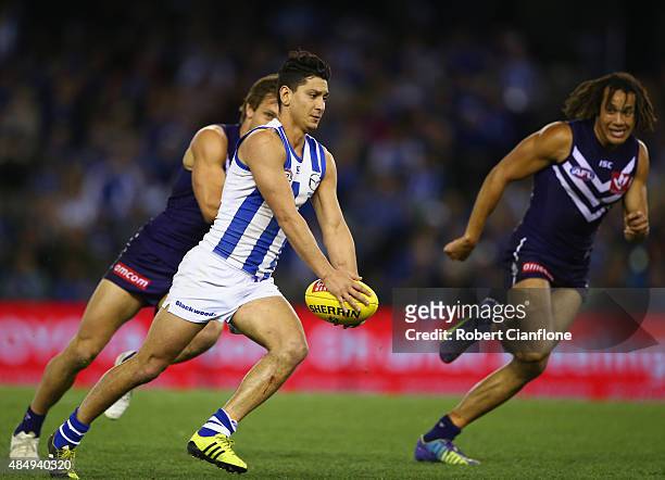 Robin Nahas of the Kangaroos runs with the ball during the round 21 AFL match between the North Melbourne Kangaroos and the Fremantle Dockers at...