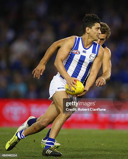 Robin Nahas of the Kangaroos runs with the ball during the round 21 AFL match between the North Melbourne Kangaroos and the Fremantle Dockers at...