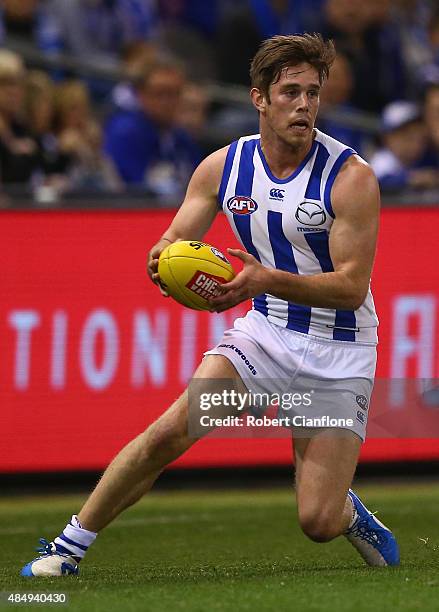 Ryan Bastinac of the Kangaroos controls the ball during the round 21 AFL match between the North Melbourne Kangaroos and the Fremantle Dockers at...