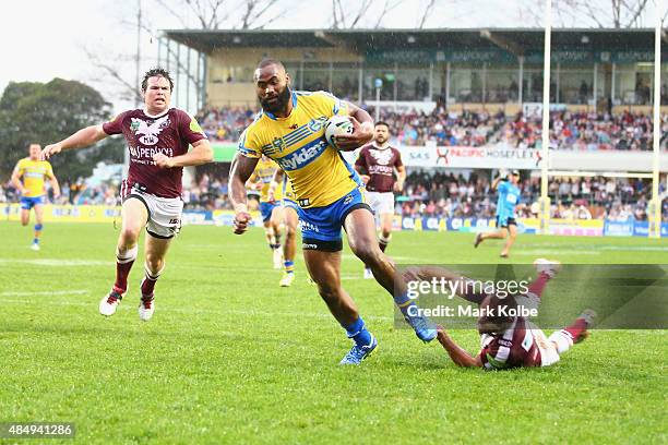 Semi Radradra of the Eels breaks the tackle of Brett Stewart of the Eagles as he scores a try during the round 24 NRL match between the Manly...