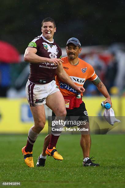 Matt Ballin of the Eagles grimaces as he leaves the field with a trainer during the round 24 NRL match between the Manly Warringah Sea Eagles and the...