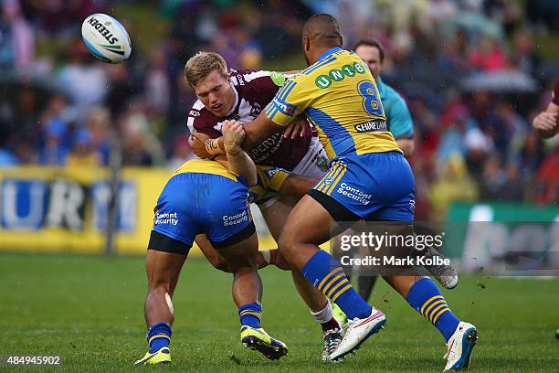 Jake Trbojevic of the Eagles loses the ball as he is tackled during the round 24 NRL match between the Manly Warringah Sea Eagles and the Parramatta...