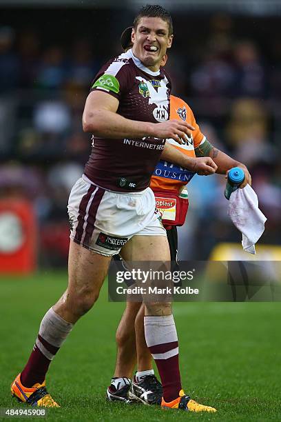 Matt Ballin of the Eagles grimaces as he leaves the field with a trainer during the round 24 NRL match between the Manly Warringah Sea Eagles and the...