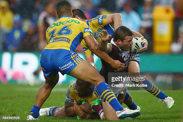 Blake Leary of the Eagles is tackled during the round 24 NRL match between the Manly Warringah Sea Eagles and the Parramatta Eels at Brookvale Oval...