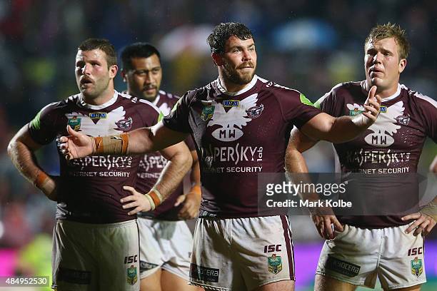 Blake Leary, Josh Starling and Jake Trbojevic of the Eagles look dejected during the round 24 NRL match between the Manly Warringah Sea Eagles and...