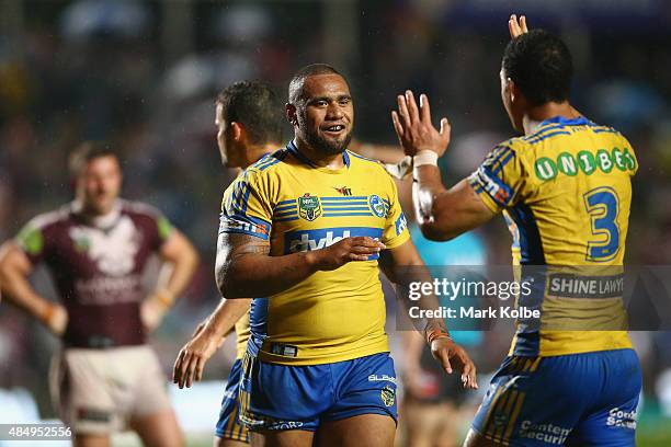 Junior Paulo and Will Hopoate of the Eels celebrate victory during the round 24 NRL match between the Manly Warringah Sea Eagles and the Parramatta...