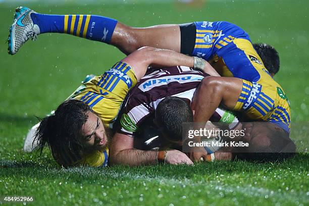 Blake Leary of the Eagles is tackled during the round 24 NRL match between the Manly Warringah Sea Eagles and the Parramatta Eels at Brookvale Oval...