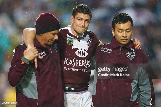 Matt Ballin of the Eagles leaves the field with the trainers during the round 24 NRL match between the Manly Warringah Sea Eagles and the Parramatta...
