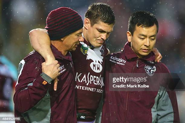 Matt Ballin of the Eagles leaves the field with the trainers during the round 24 NRL match between the Manly Warringah Sea Eagles and the Parramatta...