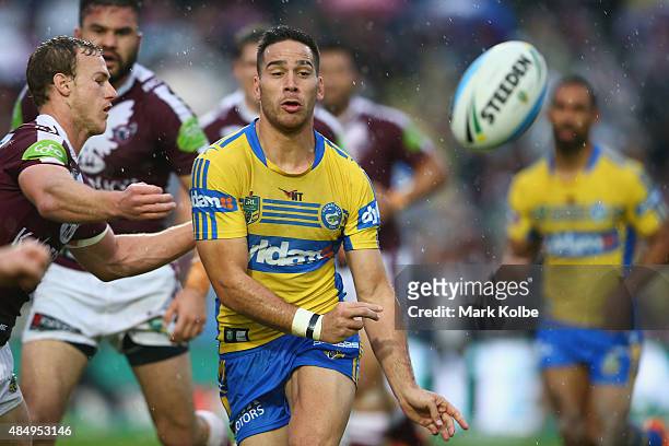 Corey Norman of the Eels passes during the round 24 NRL match between the Manly Warringah Sea Eagles and the Parramatta Eels at Brookvale Oval on...