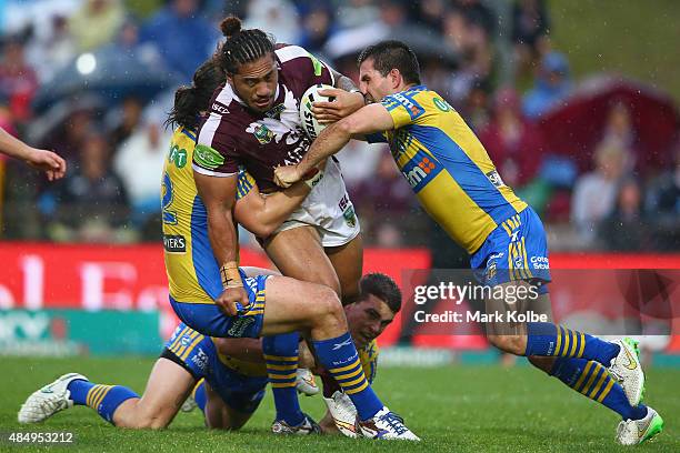 Jorge Taufua of the Eagles is tackled during the round 24 NRL match between the Manly Warringah Sea Eagles and the Parramatta Eels at Brookvale Oval...