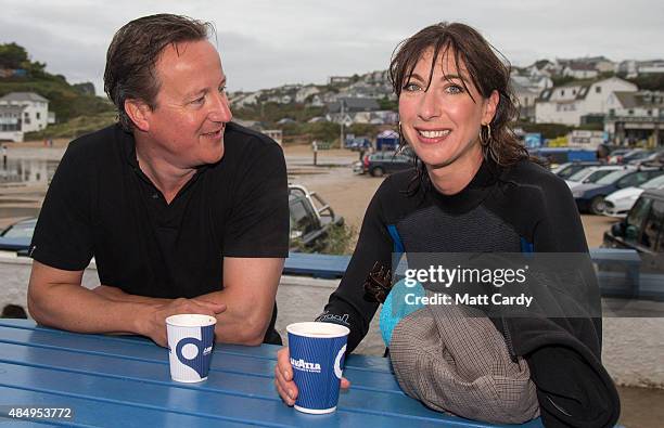 British Prime Minister David Cameron and his wife Samantha have a coffee outside the Galleon Beach Cafe following an early morning swim in the sea...
