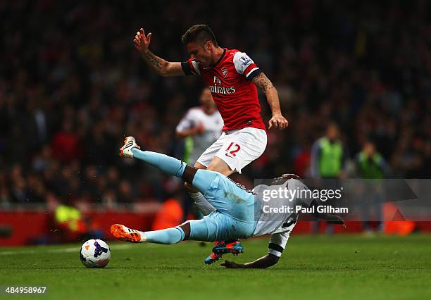 Olivier Giroud of Arsenal holds off Pablo Armero of West Ham United during the Barclays Premier League match between Arsenal and West Ham United at...