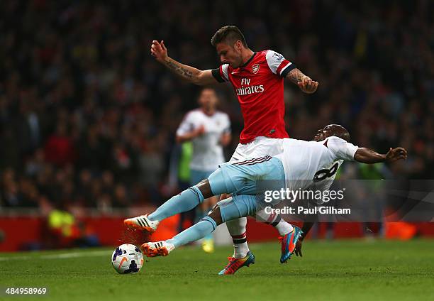 Olivier Giroud of Arsenal holds off Pablo Armero of West Ham United during the Barclays Premier League match between Arsenal and West Ham United at...