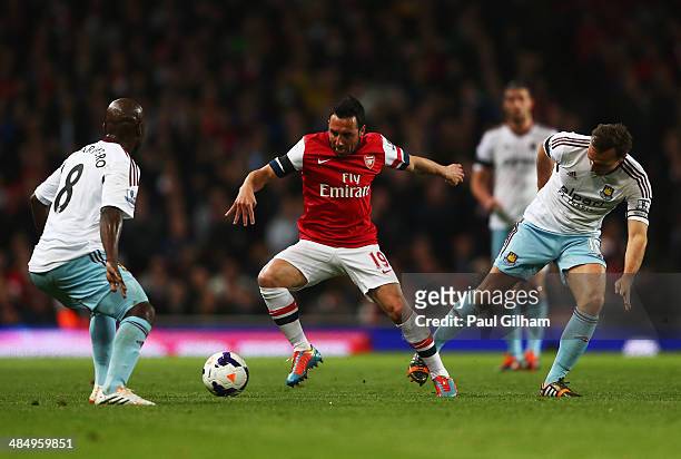 Santi Cazorla of Arsenal takes on Pablo Armero and Mark Noble of West Ham United during the Barclays Premier League match between Arsenal and West...