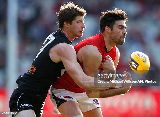 Chris Dawes of the Demons and Sam Rowe of the Blues compete for the ball during the 2015 AFL round 21 match between the Carlton Blues and the...