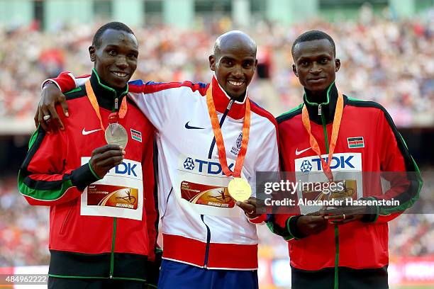 Silver medalist Geoffrey Kipsang Kamworor of Kenya, gold medalist Mohamed Farah of Great Britain and bronze medalist Paul Kipngetich Tanui of Kenya...