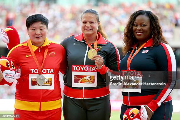 Silver medalist Lijiao Gong of China, gold medalist Christina Schwanitz of Germany and bronze medalist Michelle Carter of the United States pose on...