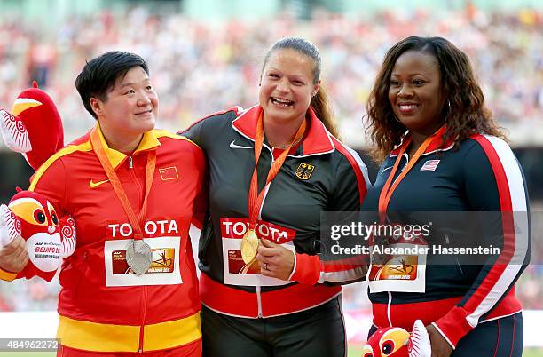 Silver medalist Lijiao Gong of China, gold medalist Christina Schwanitz of Germany and bronze medalist Michelle Carter of the United States pose on...