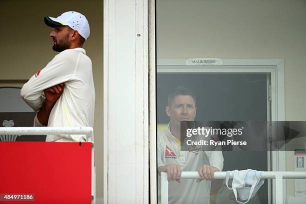 Nathan Lyon and Michael Clarke of Australia look on from the change rooms after rain stopped play during day four of the 5th Investec Ashes Test...