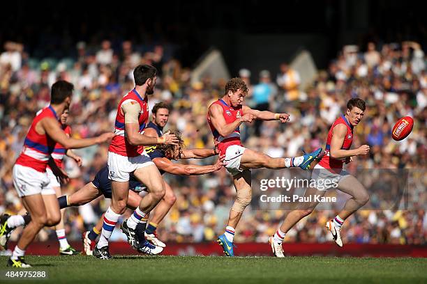 Mitch Wallis of the Bulldogs kicks the ball into the forward line during the round 21 AFL match between the West Coast Eagles and Western Bulldogs at...