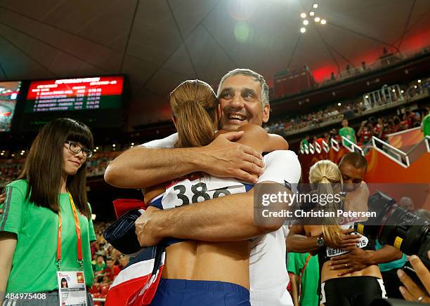 Jessica Ennis-Hill of Great Britain embraces coach Toni Minichiello after winning the Women's Heptathlon 800 metres and the overall Heptathlon gold...
