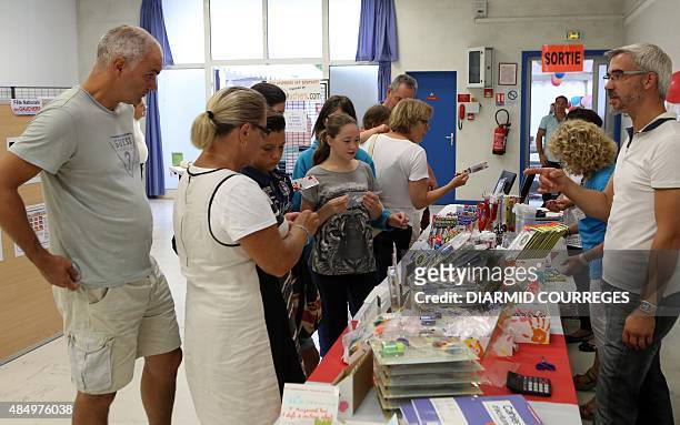 People look at objets for lefties in the Salle du Pont du Buy in Brive-la Gaillarde, where writing and cooking workshops were organised and objets...