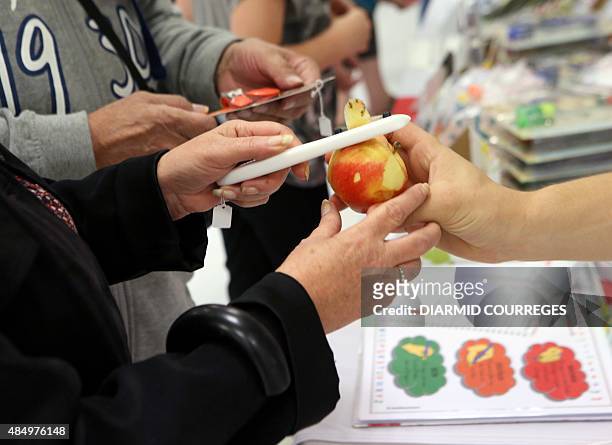 Person peels an apple with a peeler for left-handed users in the Salle du Pont du Buy in Brive-la Gaillarde, where writing and cooking workshops were...